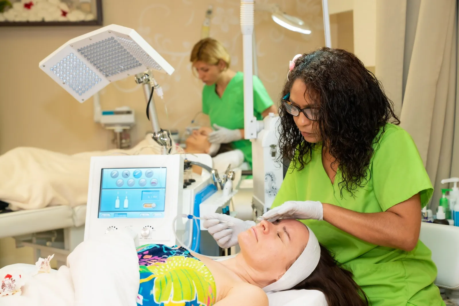 A Kiwi Spa esthetician analyzing a client's skin before the facial
